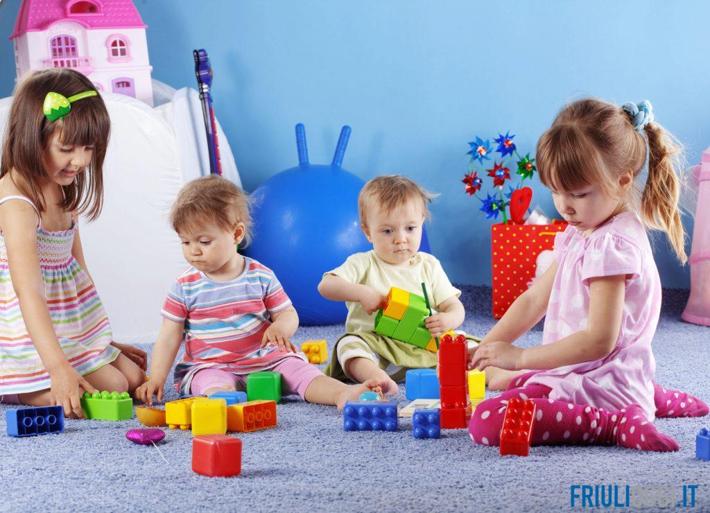 Bambini che giocano in un asilo nido, simbolo del benessere sociale in Friuli Venezia Giulia